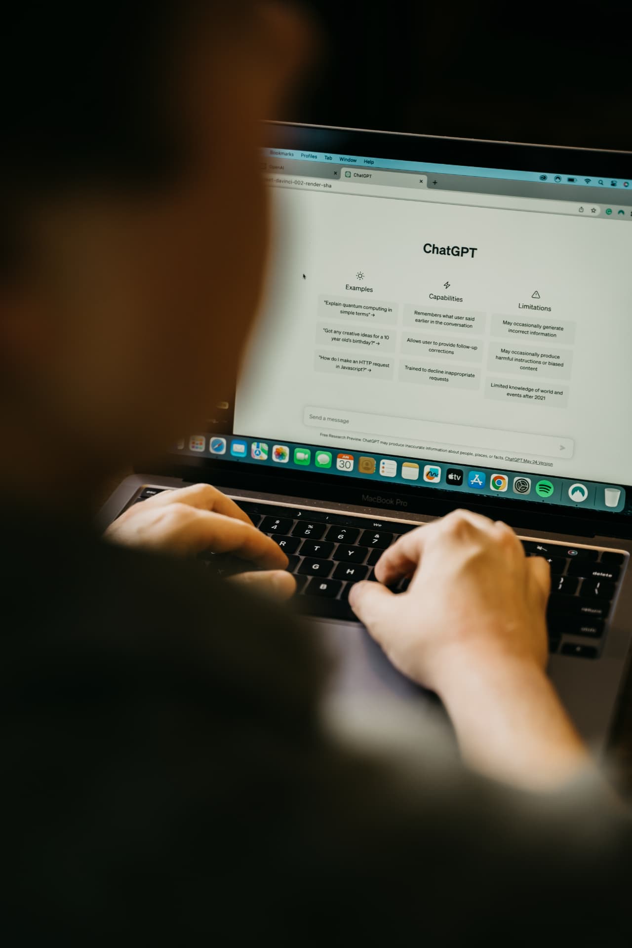 Person working at a laptop with an AI chat assistant open on screen